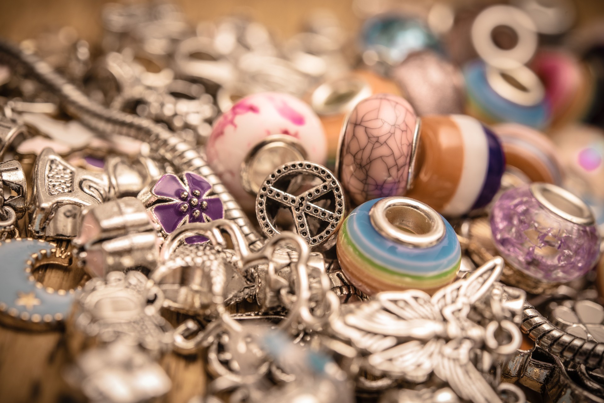 Colorful Silver Charms Featuring Peace Sign Reflecting 1960s Themes of Love, Freedom, and Harmony